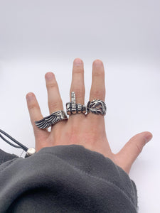 Lifestyle image showcasing The Tormented Dragon Ring, Big Wing Ring, and Fuck You Ring, all crafted from durable Stainless Steel. Embrace a bold and stylish statement in everyday life with this unique collection of rings.